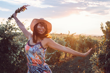 Beautiful woman walking in vineyard in nature. Happy people lifestyle.