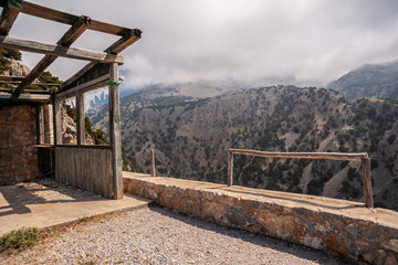 Building and fence on the background of fog in the mountains