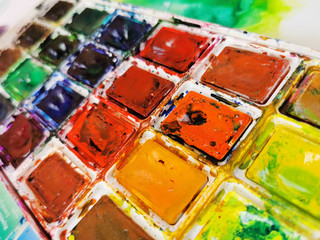 set of watercolor paints in ditch while using drawing