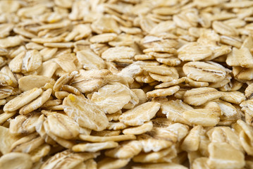 organic healthy pile of dry oat flakes, texture background.