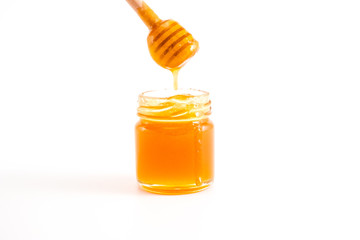 honey and honey in jar on white background