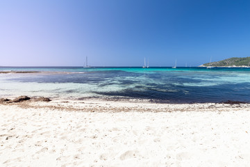 Fototapeta na wymiar Finest white sand on one of the most beautiful beaches Ses Salines in Ibiza island