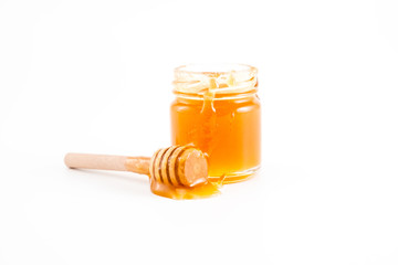 honey and honey in jar on white background