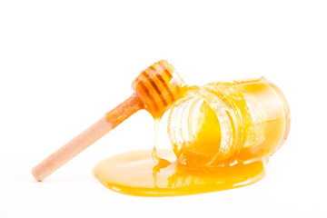 honey and honey in jar on white background