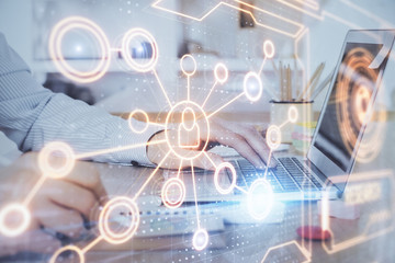 Social network theme hologram with businessman working on computer on background. Concept of world wide web. Multi exposure.