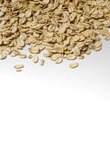 the organic healthy raw oat flakes on white background with copy space border.