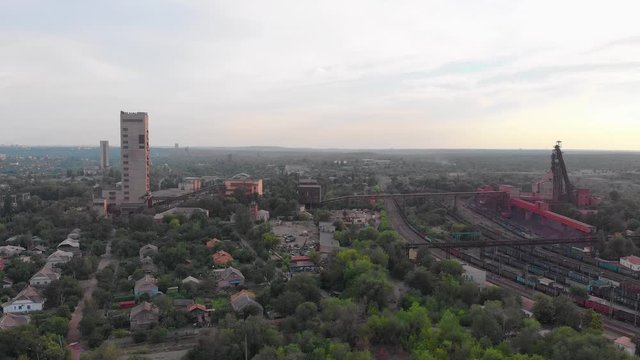 Industrial mine building red iron ore headframe aerial drone forward push in camera movement Krivoy Rog Ukraine