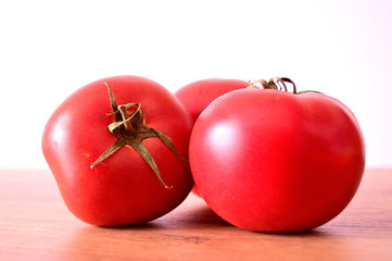 Tomatoes on wooden background 