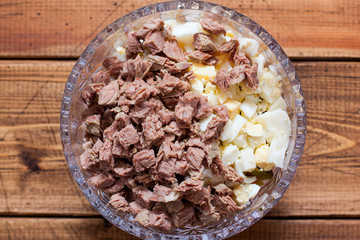Step by step cooking Olivier salad with beef, step 4 - adding chopped boiled beef, top view, selective focus