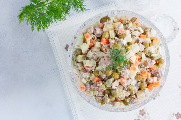 Classic festive salad Olivier with beef, top view, horizontal, copy space