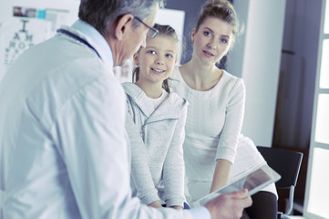Little girl with her mother at a doctor on consultation