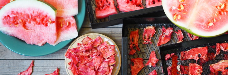Autumn season for making blanks. View from above. The process of preparing sweet treats for future use, from whole green watermelon to dried slices of homemade dried watermelon fruit on a