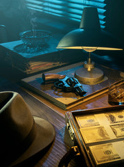 Film noir style desktop with revolver and cash money