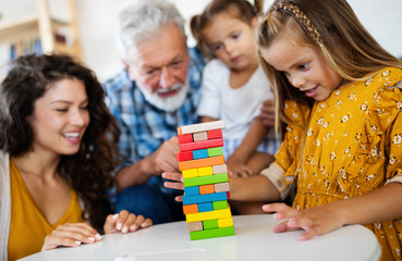Happy family playing together and having fun at home