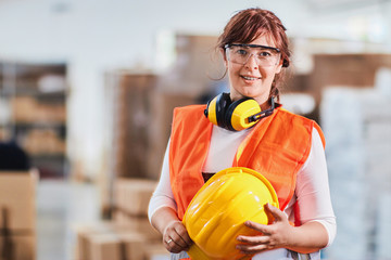 Portrait of a women worker in a factory wearing protective wear