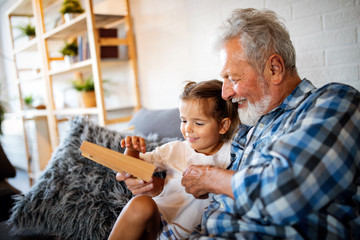 Grandparent playing and having fun with their granddaughter