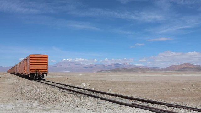 Mineral train near Uyuni Boliva passes to reveal volcanic desert landscape