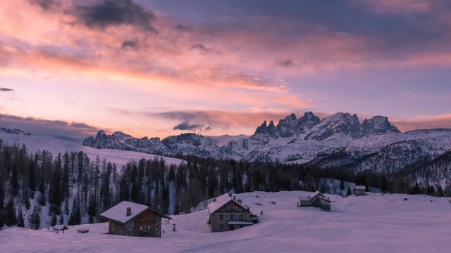 Time lapse of a soft sunrise over Dolomiti mountins during the winter