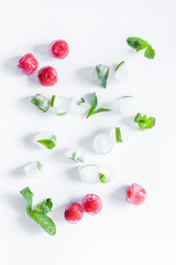 Berries frozen in ice cubes background flat lay