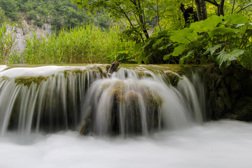 Long exposure of water flowing over a small waterfall at Plivice Lakes, Croatia