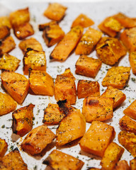 Roasted oven baked sliced pumpkin - vegetarian food cooking