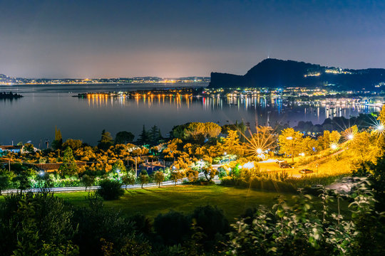 Night time in Manerba del Garda with the silhouettes of the mountains in the background on Lake Garda, Italy