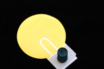 Miniature of a barrel on an applique in the form of a light bulb on a black background. Selective focus. Space for lettering and design
