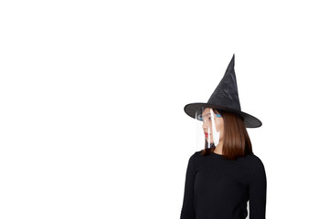 Woman wearing witch costume and mask face shield for Halloween