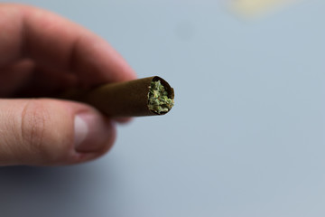 Cannabis blunt in hand close-up. Copy space background for text
