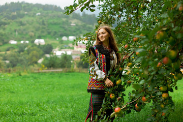 girl in embroidery under an apple tree