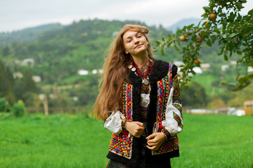 girl in embroidery under an apple tree