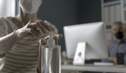 Woman applying sanitizer on her hands