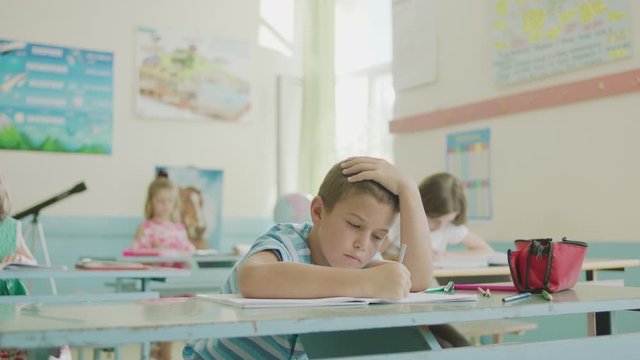 Tired student in a classroom of an elementary school.