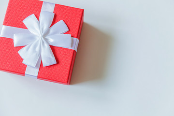 Christmas New Year birthday valentine celebration present romantic concept. Simply minimal design red gift box isolated on white background. Flat lay top view copy space.
