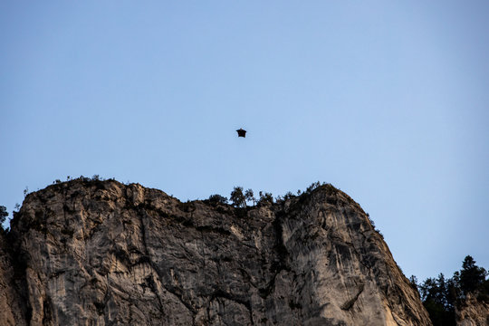 People Doing Base Jump With Wing Suit From The Mountain In Austria