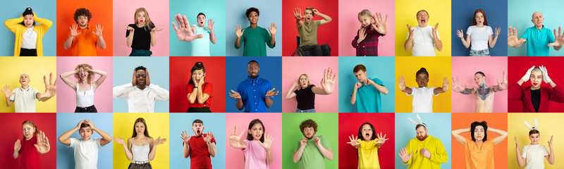 Collage of portraits of 26 young emotional people on multicolored background. Concept of human...