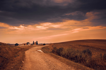 Beautiful sunset over the Tuscany hills and fields. Travel destination Tuscany