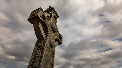 Celtic cross gravestone , cloudy dramatic sky background