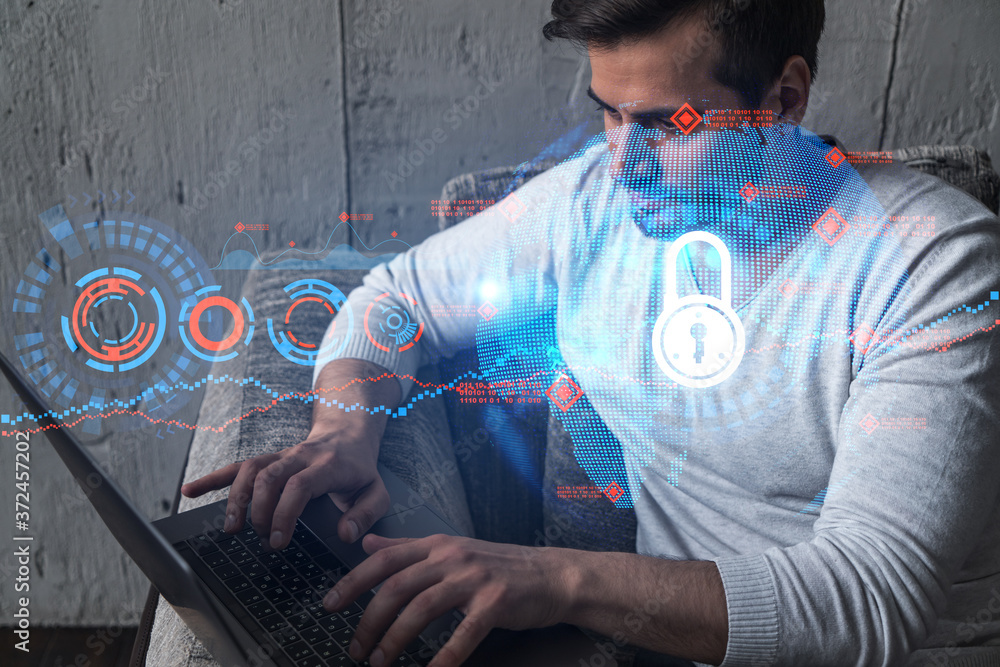 Poster a serious caucasian programmer in casual wears, using laptop to develop a new security system to pro