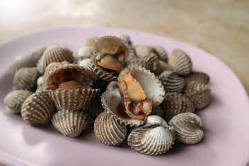 Close up seafood Thailand menu called Hoi Krang Pao or Grilled Cockle on a plate.