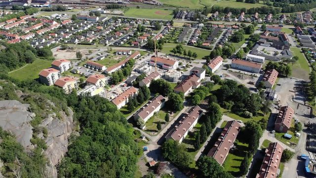 Aerial drone above Utby district by mountain in Gothenburg, day, forward