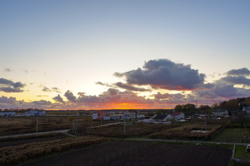 Fototapeta na wymiar Sunset over the fields. Village in the sun.