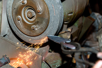 Blacksmith, knife sharpening, sparks, metal.