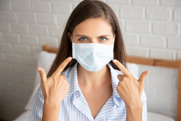 White woman recommending you to wear face mask in your home