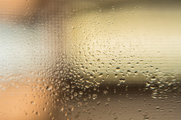 Fototapeta na wymiar Drops of water slipping on a glass