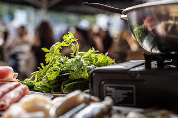 Hot pot with food over restaurant table