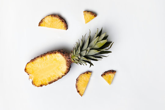 Ripe delicious half pineapple on gray background with copy space