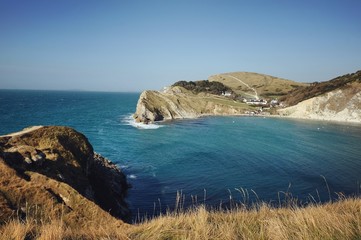 Looking towards West Point on a  calm  Lulworth Cove on the Jurassic Coast, Dorset, UK