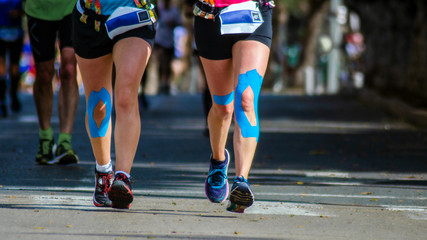 Naklejka premium people running in marathon kilometer road walking shots shoe women