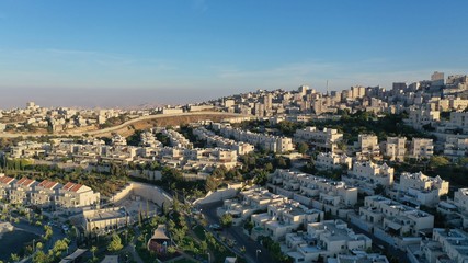 Fototapeta na wymiar Israel and Palestine town divided by wall, aerial pisgat zeev and anata refugees camp, Jerusalm israel 